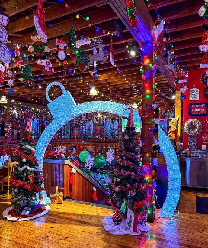 A giant illuminated ornament archway built as a holiday photo op