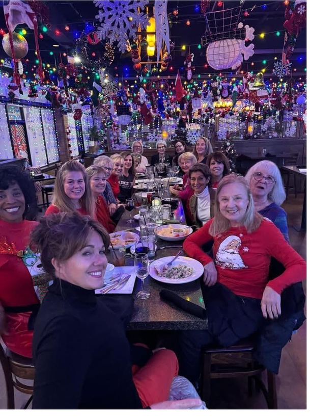 A happy group celebrating together at a long festive table