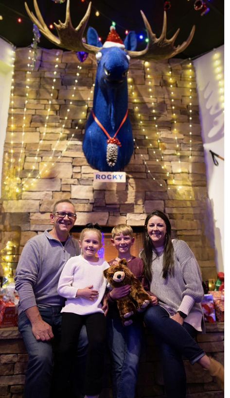A family posing for a photo beneath the restaurant's holiday décor