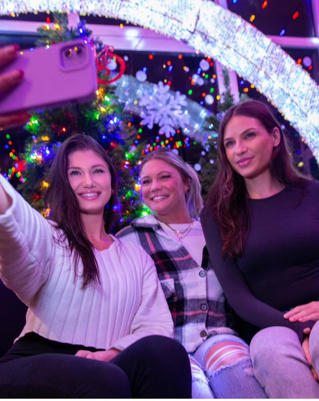 Friends gathered close for a cheerful holiday photo
