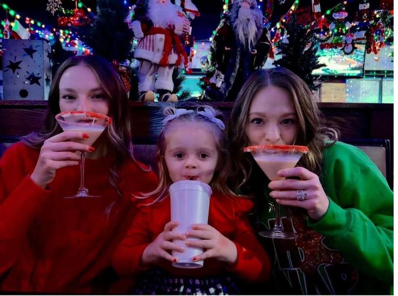 Guests raising festive holiday drinks in a toast