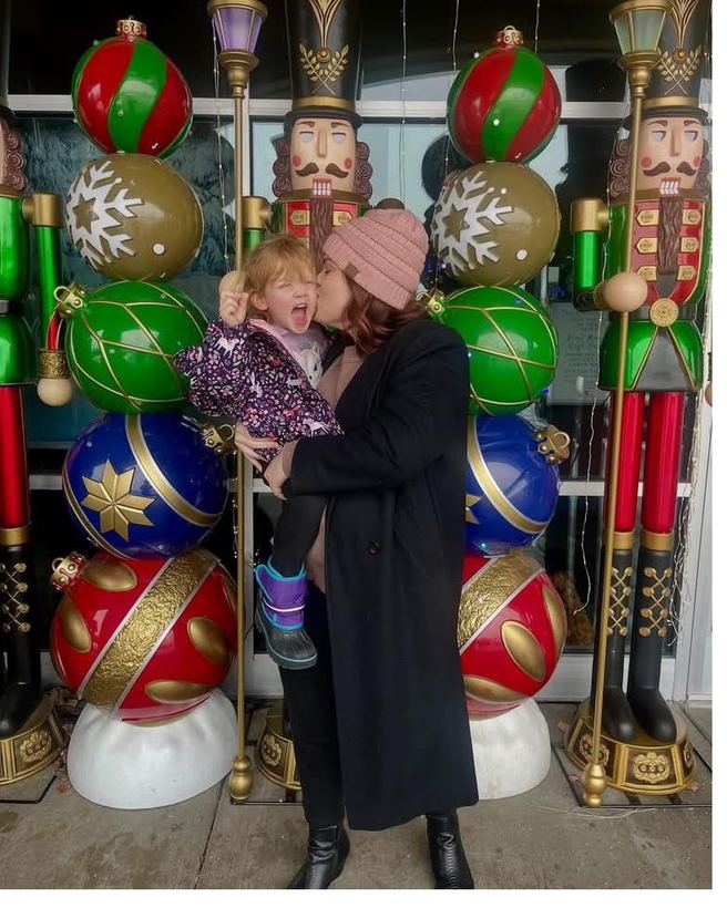 A couple sharing a moment beside giant nutcrackers